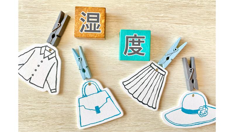 「湿度」と書かれた木のブロックと衣類のオブジェ